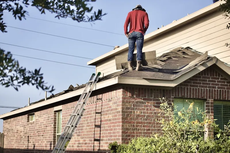 Professional roofer working on a residential roof in Downtown Houston